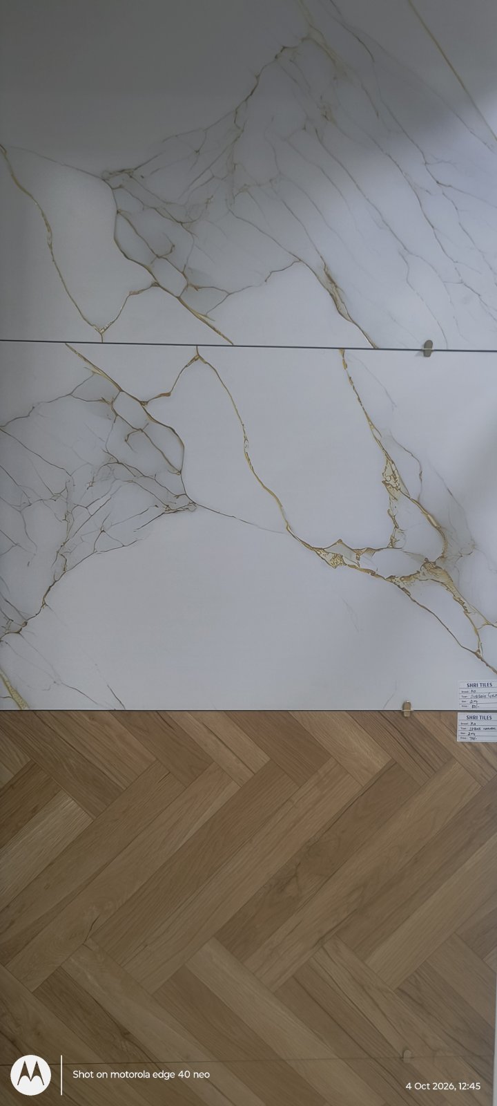 Marble-effect vitrified tile with a herringbone wood-effect floor tile at Shri Tiles