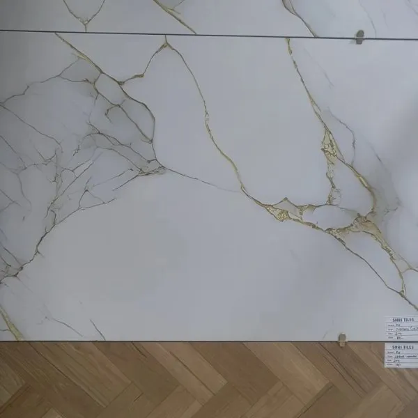 Marble-effect tile with a herringbone wood-effect floor tile displayed at Shri Tiles, Jalahalli, Bengaluru